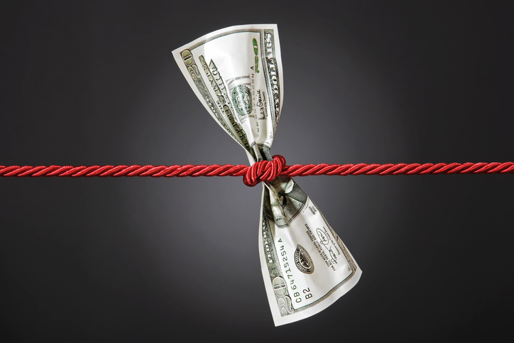 Tug of war with dollar on gradient background